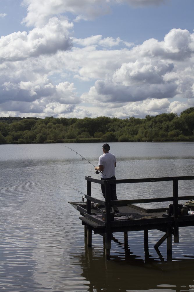 A person fishing at Worsbrough Mill's small pier