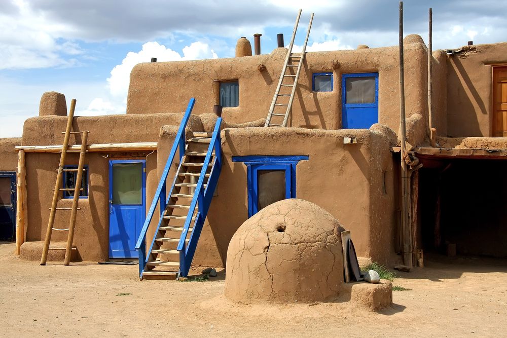 Stairs resting on a clay house at Taos Pueblo