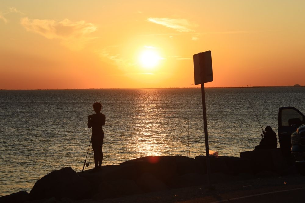 Fishing at Texas City Dike during sunset
