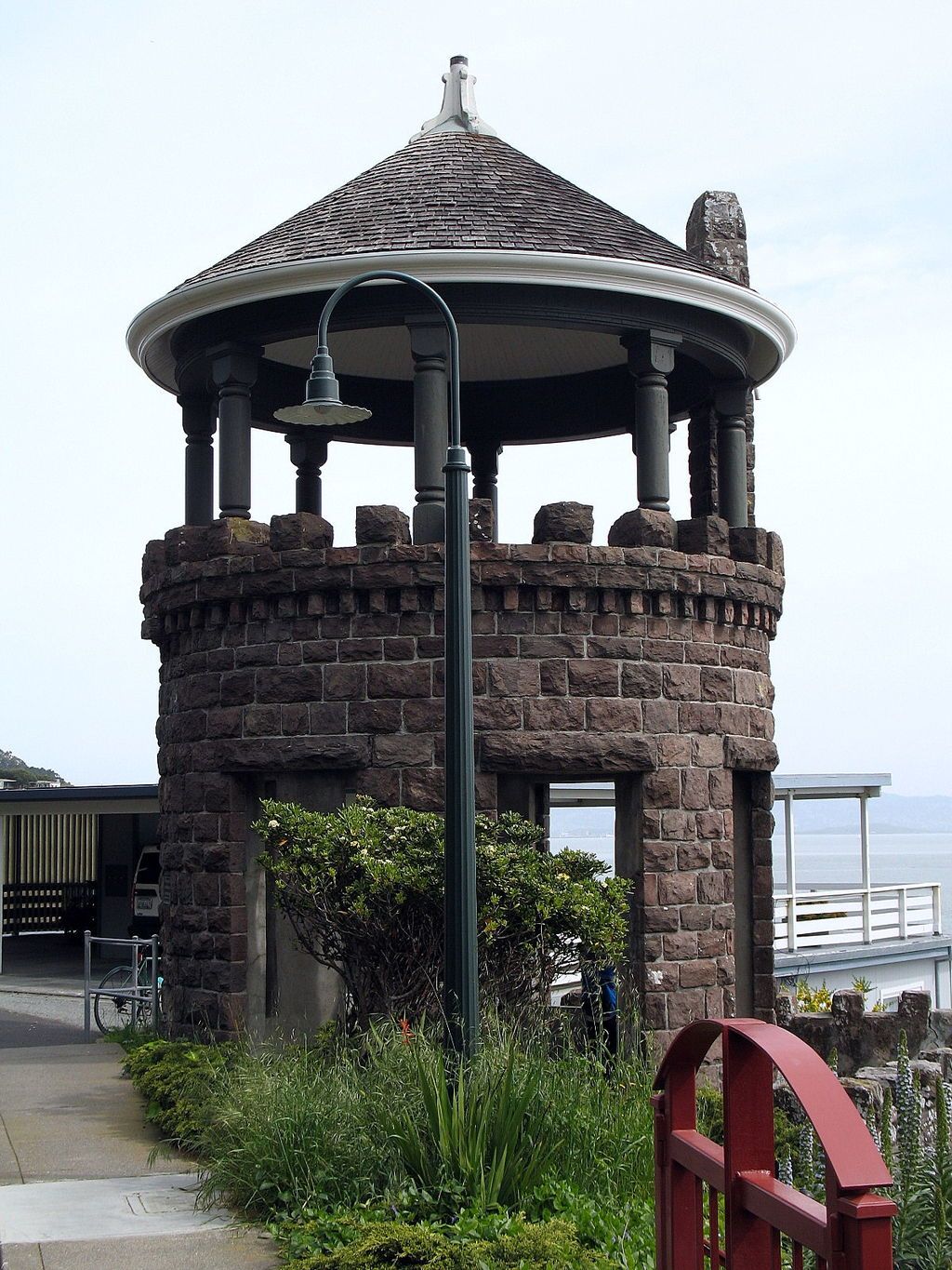 Exterior of the lyford's stone tower and a light post beside.