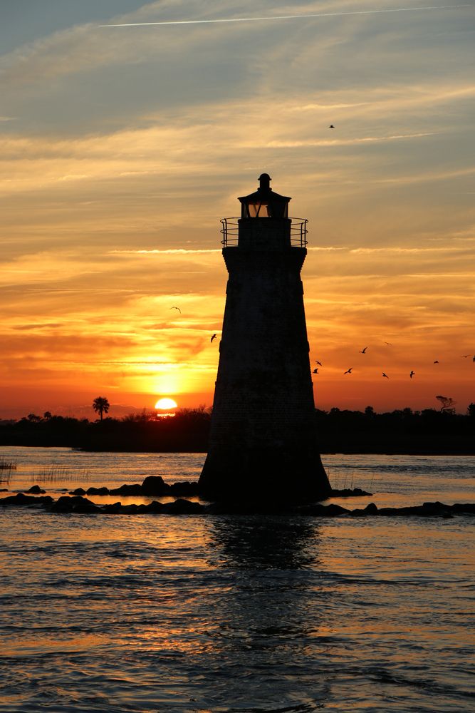 Silhouette of Cockspur Island Lighthouse during sunset