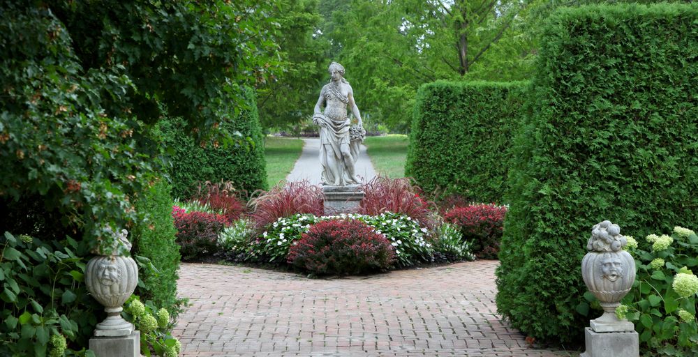 A sculpture surrounded with flora at Toledo Botanical Garden