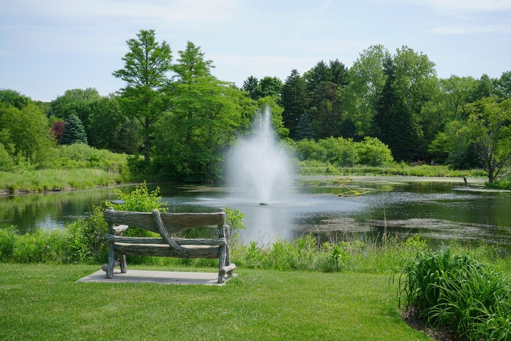 Bench overlooking Toledo Botanical Garden's pond fountain
