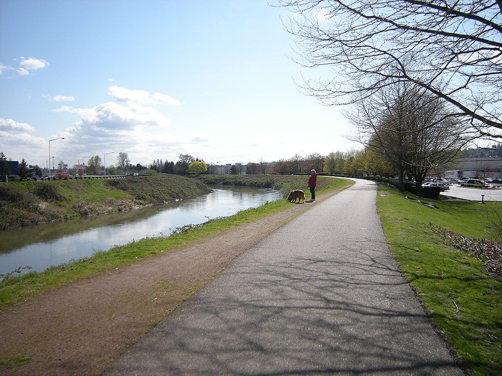 A woman walking her dog at Green River Trail.