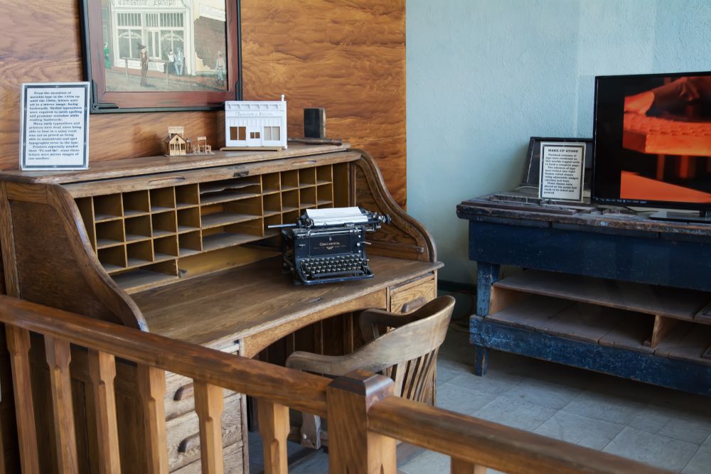 An old typewriter on a wooden table inside Tombstone Epitaph