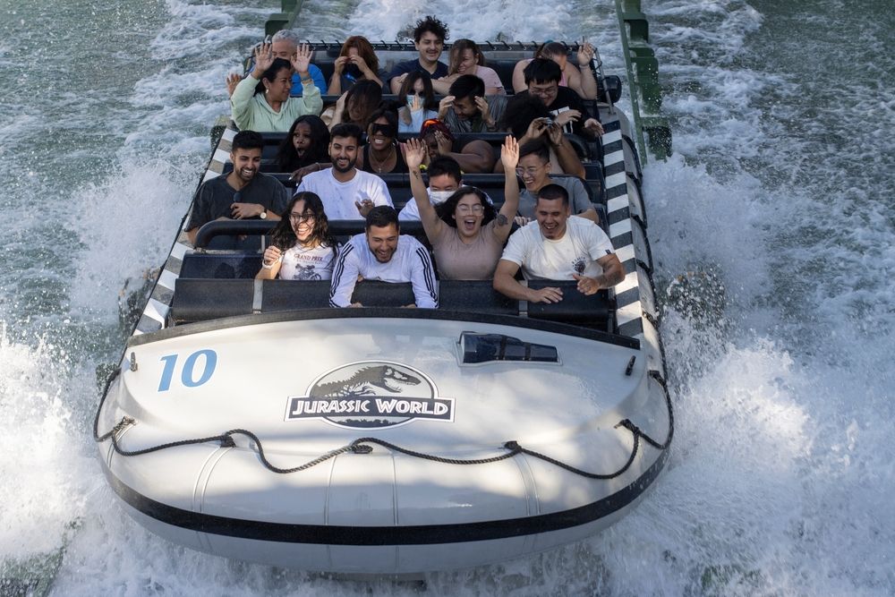 People on a riverboat at Jurassic World – The Ride