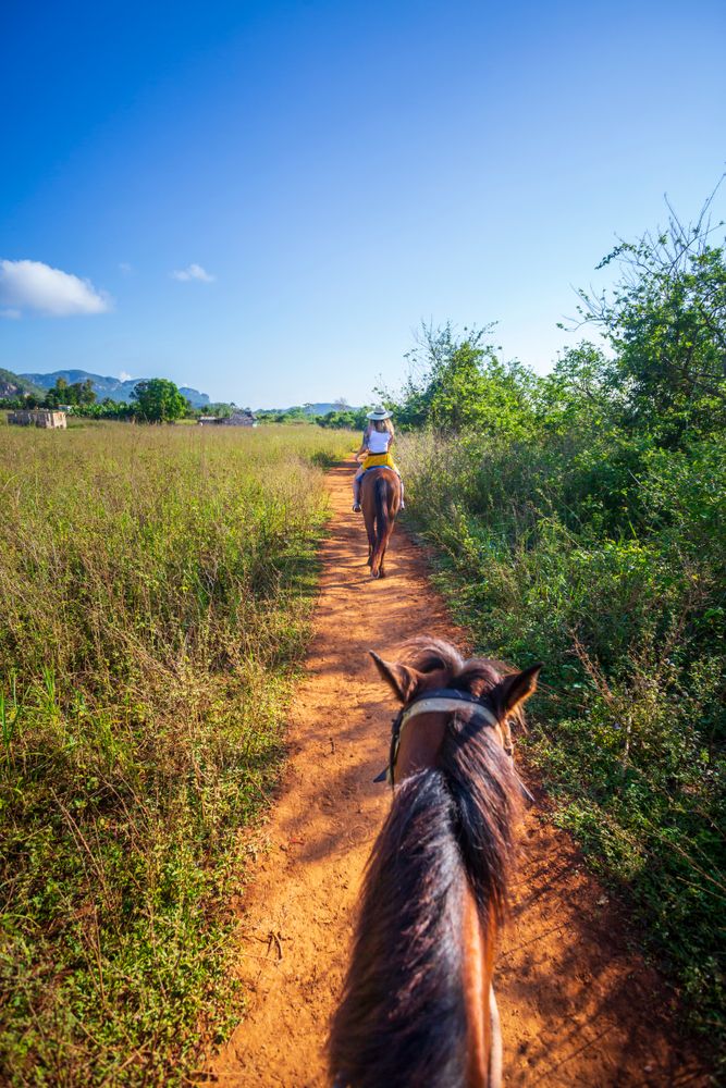 Tourist on a Horseback Riding Tour at Vinales