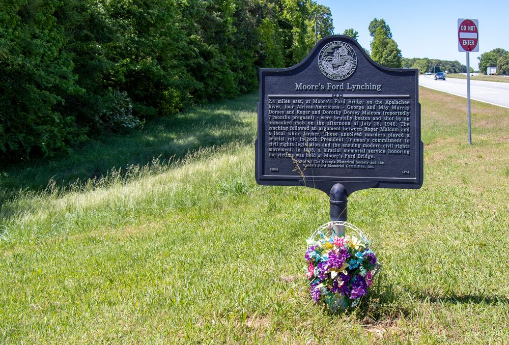 Flowers under Moore’s Ford Lynchings Historical Marker