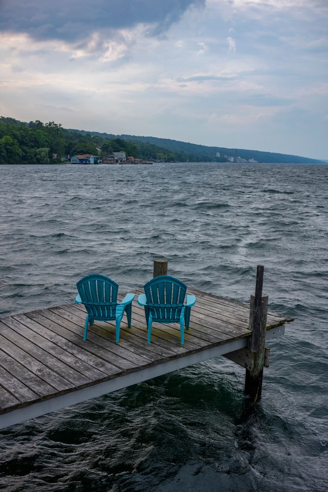 Plastic chairs on a dock overlooking Seneca Lake
