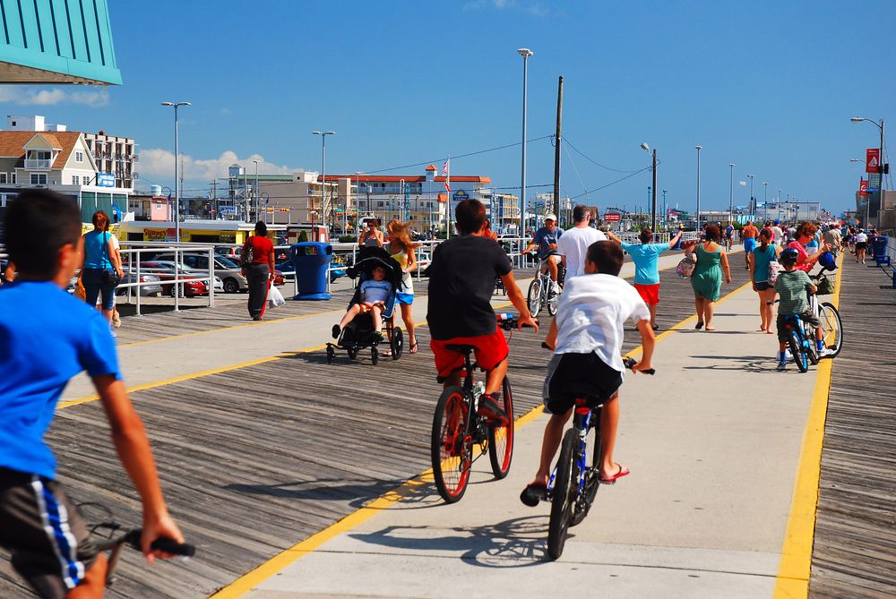 Children riding bikes along the boardwalk