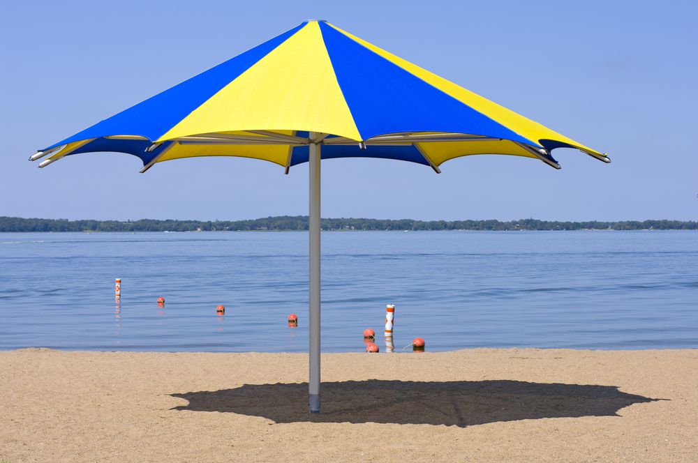 A colorful umbrella on Lake Waconia's shore