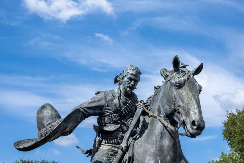 Statue of a cowboy herding cattle at Indian Spring Park