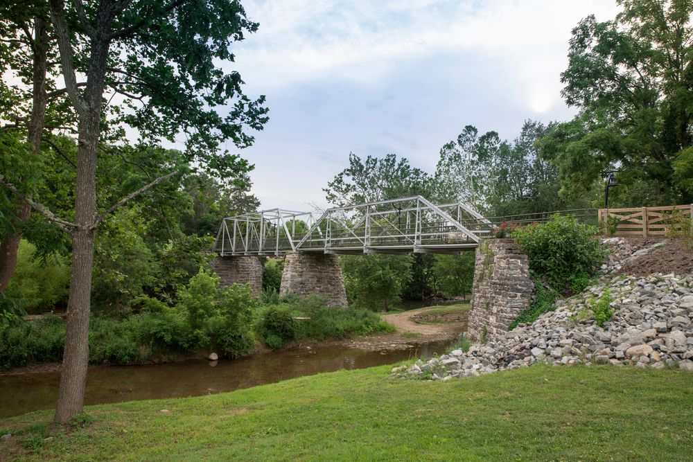A small bridge along reed creek, with trees surrounding it.