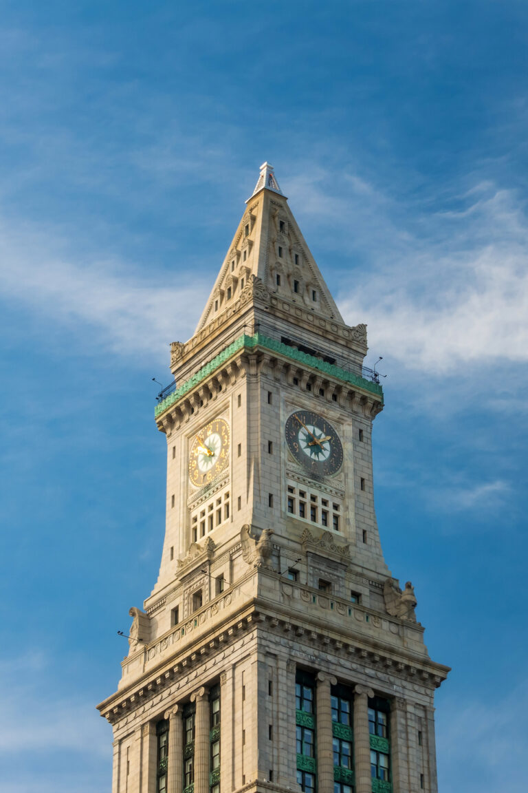 The Customs House Clock Tower stands tall against a clear blue sky, marking time with its historic elegance.