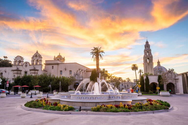 Evening descends on San Diego’s Balboa Park, casting a warm glow over its historic architecture and vibrant gardens.