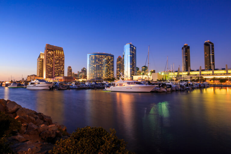 Twilight descends on the serene Marina Bay, showcasing the glittering skyline of San Diego, California.
