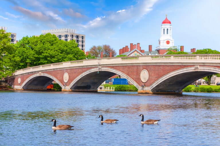 The historic bridge with its distinctive clock tower spans the Charles River, providing a picturesque route to the Harvard University campus in Boston.