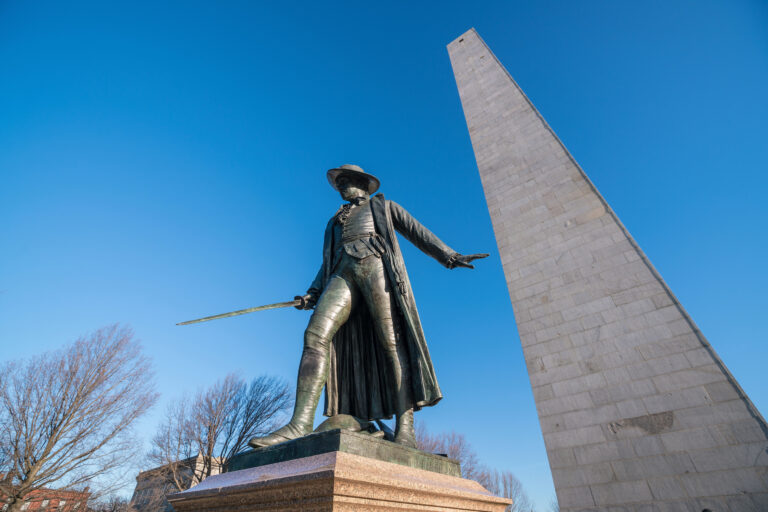 The Bunker Hill Monument stands tall against a clear blue sky, commemorating the historic battle of the American Revolution in Boston, Massachusetts.