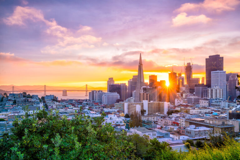 A breathtaking sunset view of downtown San Francisco, showcasing the city’s iconic skyline against a vibrant sky.