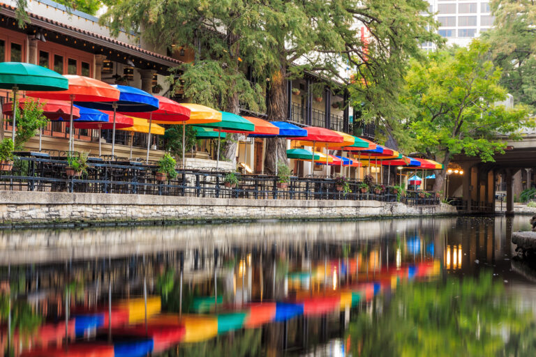 Vibrant umbrellas line the walkways of the San Antonio Riverwalk, reflecting a lively atmosphere of dining and leisure on a serene September day in 2014.